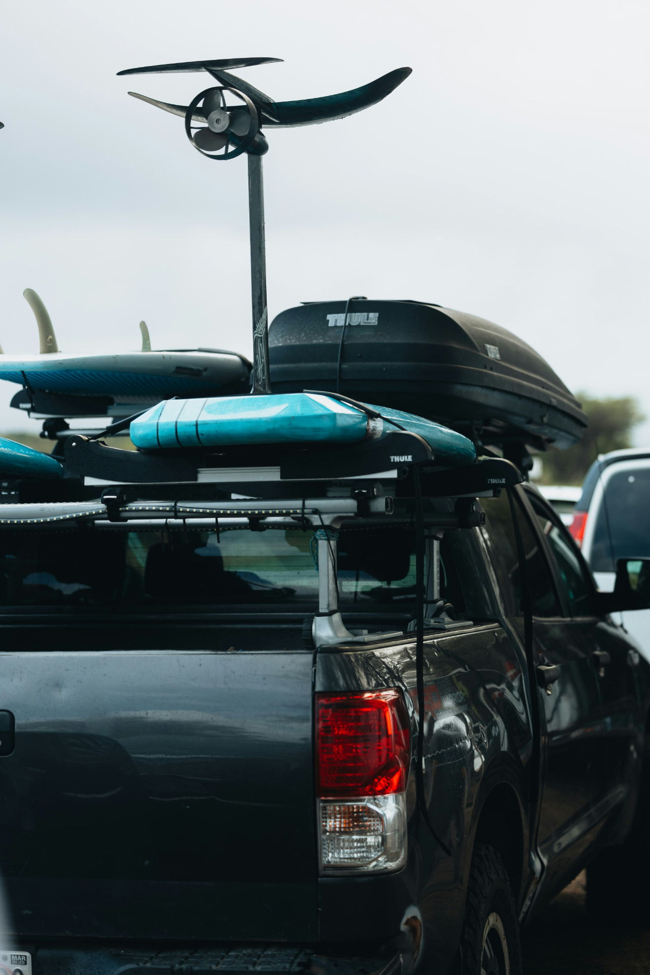 Foil kit loaded and secured on the roof rack of the eWatersports van